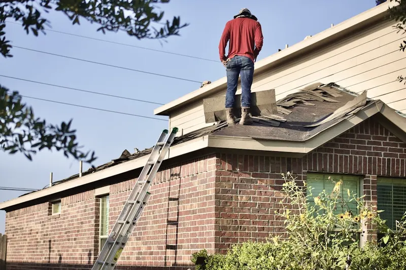 Professional roofer working on a residential roof in Meadowgreen